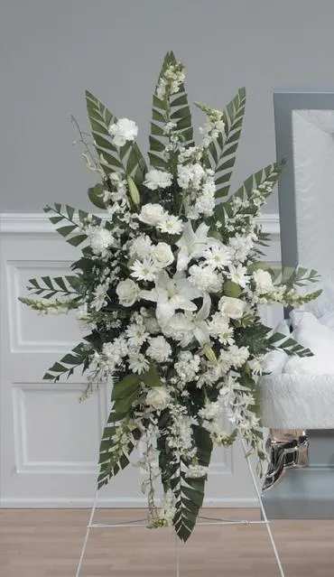 Tall white floral standing spray with lilies and daisies