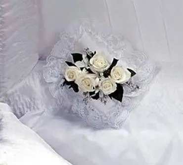 White rose bouquet with black ribbon accents on lace fabric