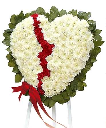 Heart-shaped white and red floral tribute on a stand