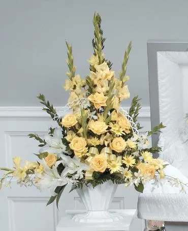 Tall yellow floral arrangement in a white vase
