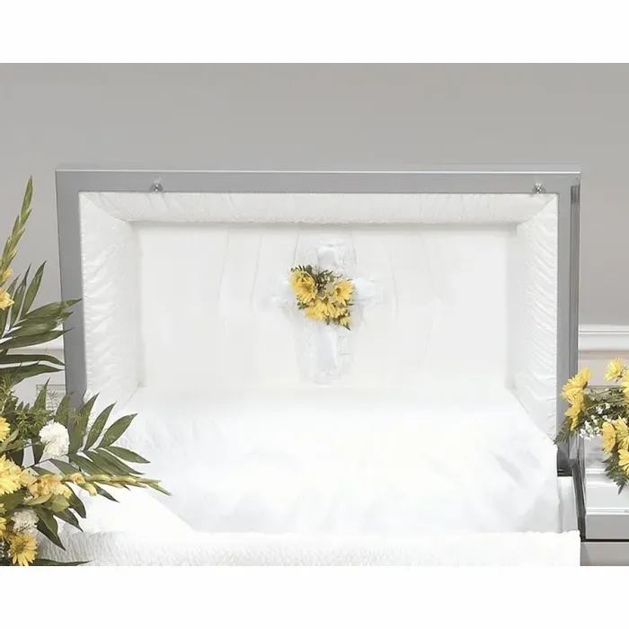 White casket with a small yellow floral spray