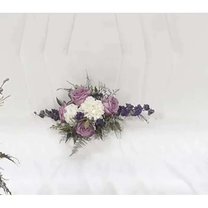 White dress with a small purple and white floral corsage