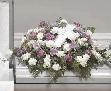 White and lavender funeral spray with roses and carnations