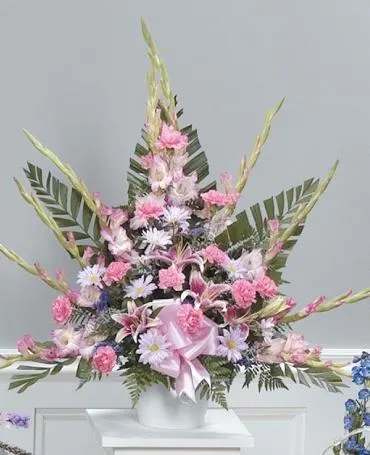 Tall pink and white floral arrangement in a white vase