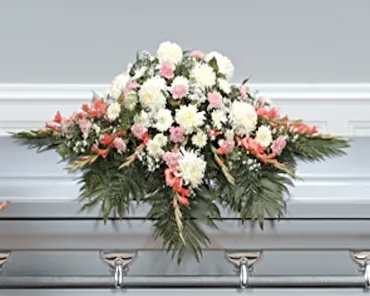 Casket spray with white and pink flowers and greenery