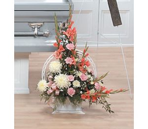 Tall floral arrangement in a clear vase with pink and white blooms