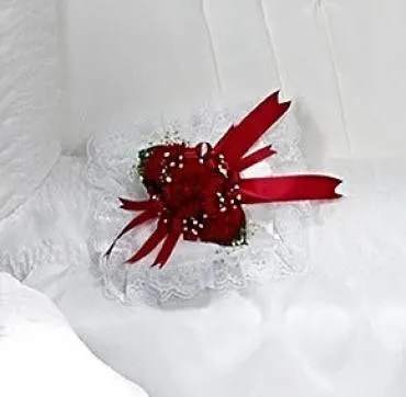 Red rose corsage with white lace and ribbon