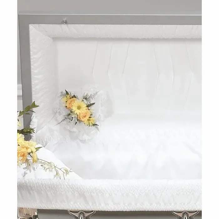White casket with small yellow floral sprays