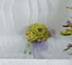 Blurred yellow-green floral arrangement with purple accents
