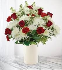 Red roses and white chrysanthemums in a white vase