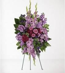 Standing floral spray with purple and pink flowers on an easel
