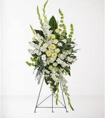 Tall white and green floral standing spray on an easel