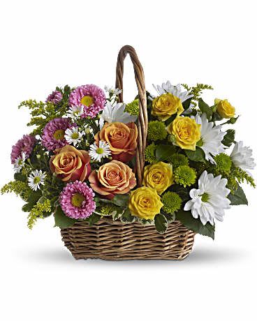 Basket of pink, orange, and yellow roses with white daisies
