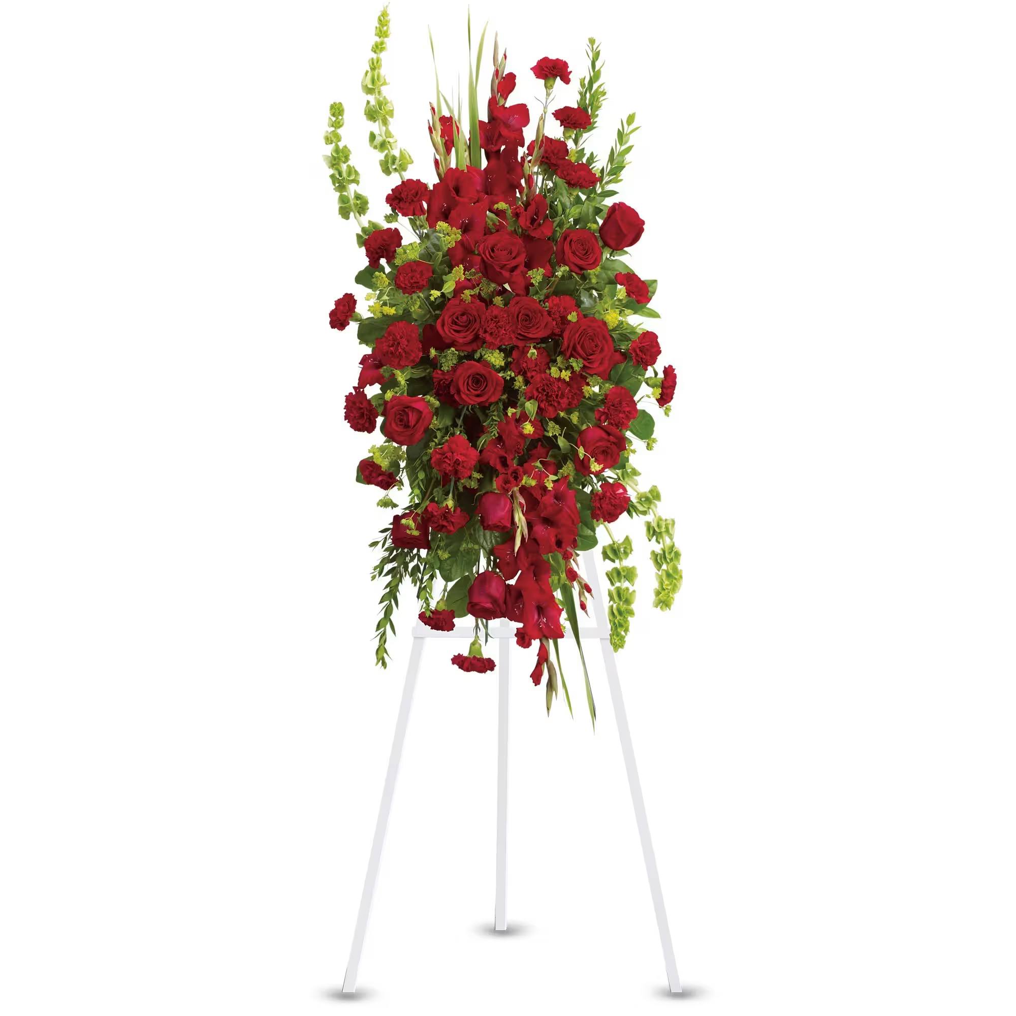 Tall red rose and carnation standing spray on a white easel