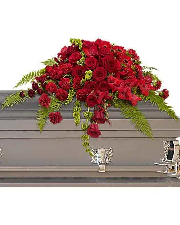 Red rose casket spray with fern accents