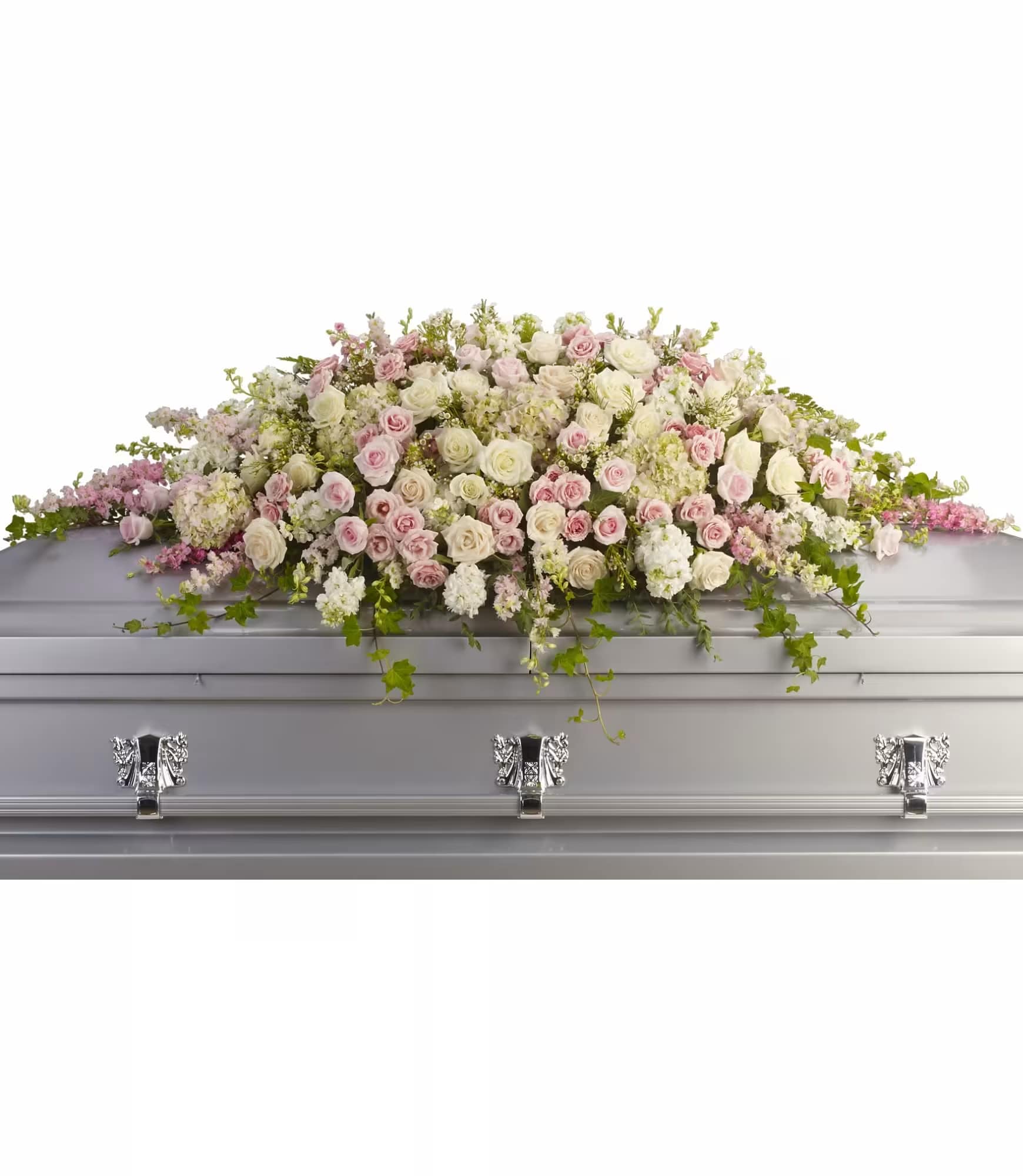 Pastel rose and white floral casket spray on a silver casket