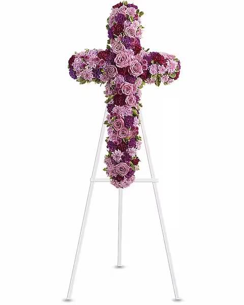 Purple and pink floral cross on a white stand