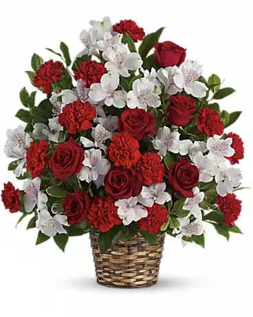 Red roses and white flowers arranged in a woven basket