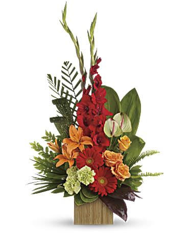 Tropical arrangement with red, orange, and green flowers in a wooden container