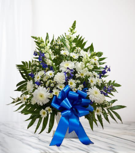 White daisy bouquet with blue flowers and a large blue ribbon