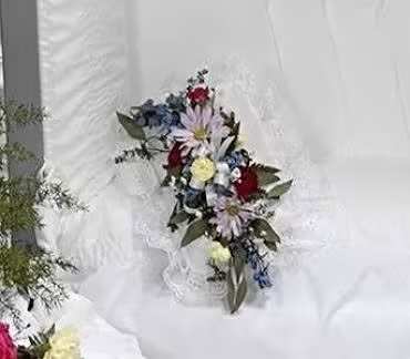White floral bouquet with red and blue accents on white fabric