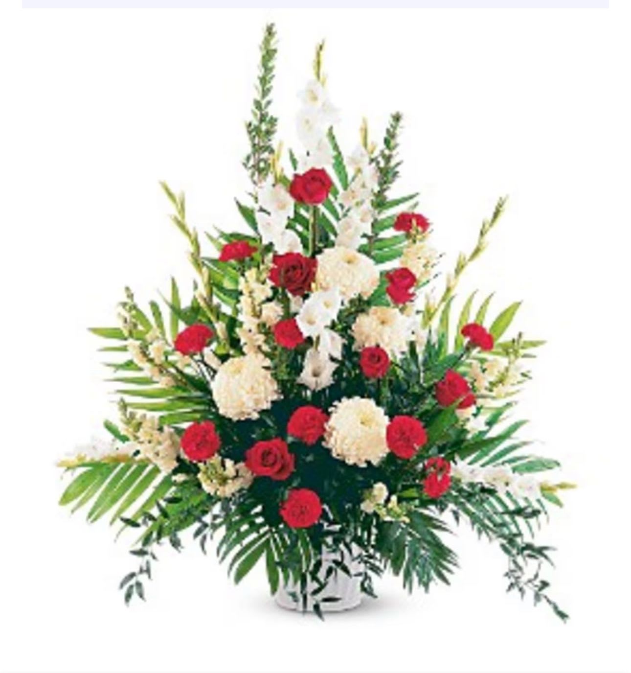 Tall floral arrangement with red and white flowers in a white container