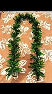 Green leafy garland arranged in a loop on a patterned surface