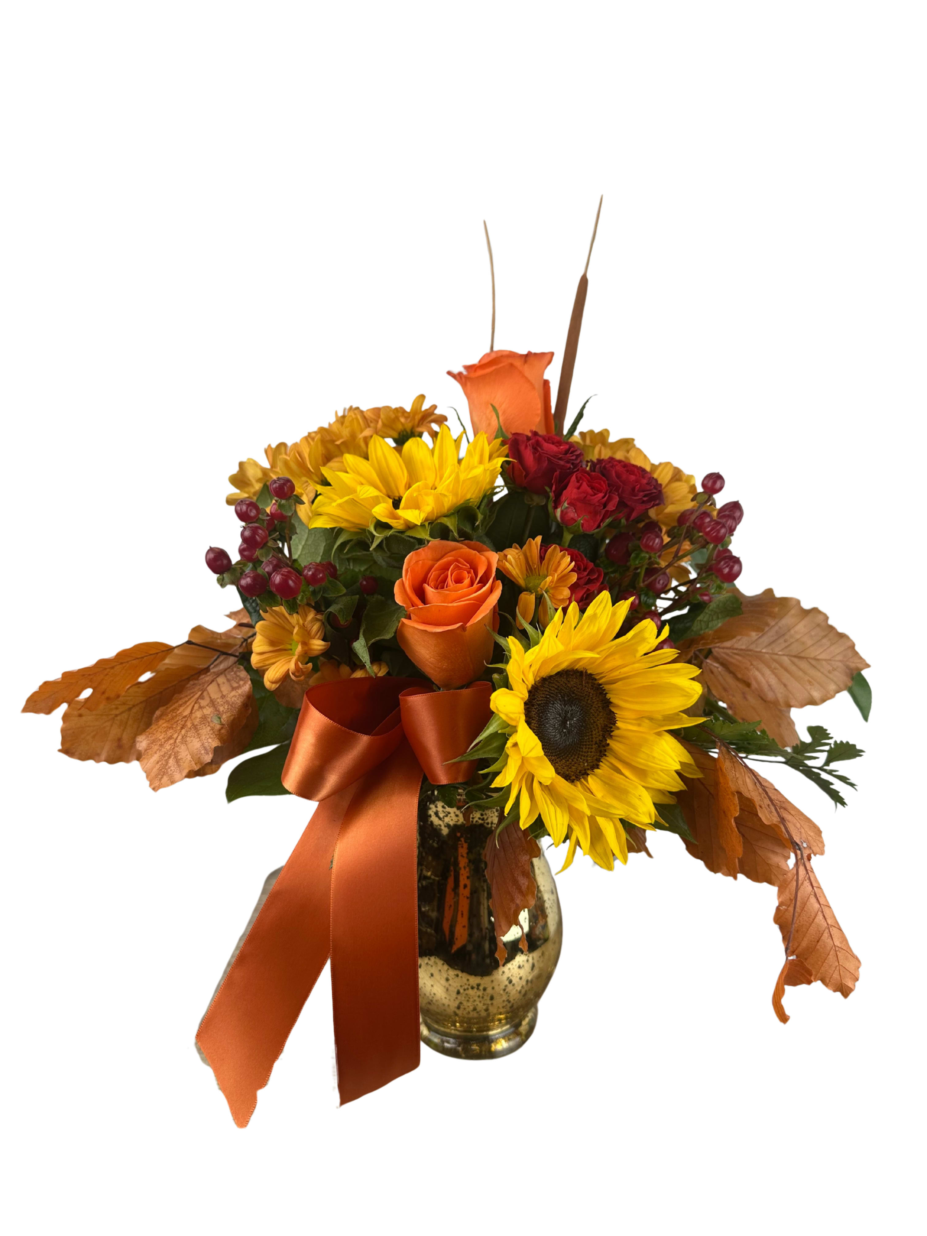 Autumn bouquet with sunflowers, roses, and a ribbon in a glass vase