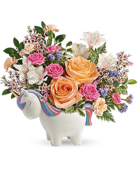 Bouquet of pink and peach roses in a unicorn-shaped ceramic container
