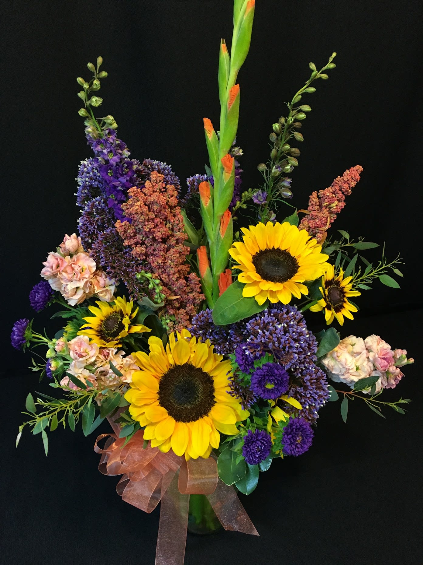 Summer Seasonal Mixed Vase - We like a good assortment of flowers and we include interesting items in addition to ones you will recognize. Flowers and greenery will vary but be assured that you will receive a unique Flower Fiesta creation worthy of sending. 