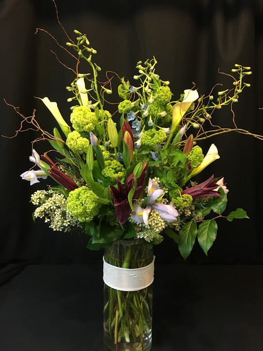 Spring Grand Lasting Show - Assortment and container may vary.  Over 2 feet tall and very hefty.  Premium vase full of spring flowers just about to bloom and willow branches at the top.  This bouquet will last and last.  Place at the center of a room - it goes all the way around!  So many spring blossoms to enjoy.