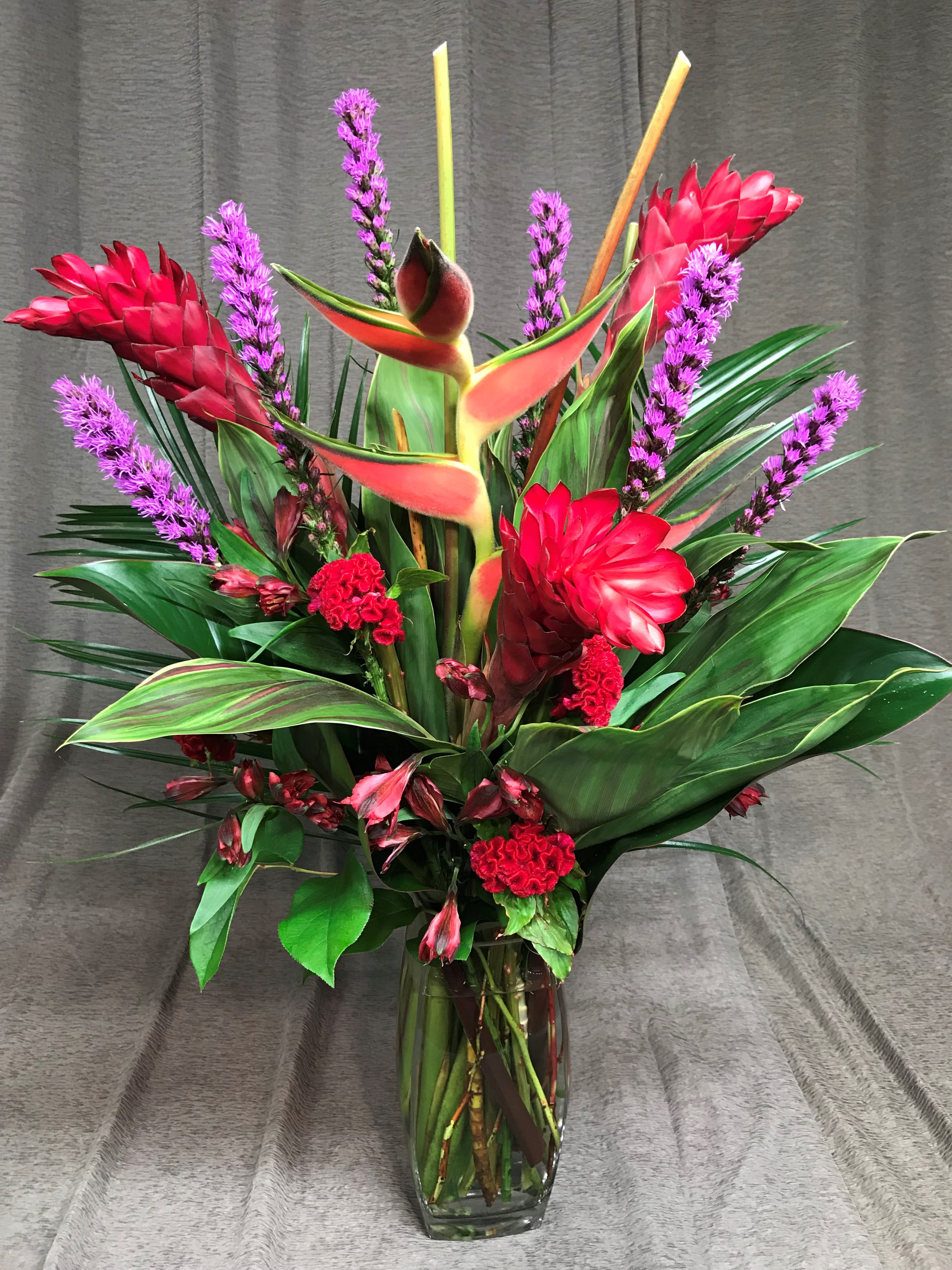 Heliconia color blast tropical valentine - Love big bold tropical flowers and a punch of color?!?! THIS is the Valentine bouquet for your sweety!!  Flowers and colors may vary.  Order at least 2 weeks in advance to allow time for us to acquire the rare heliconia and exotic flowers. 3 weeks prior if needed for Valentine's Day or major holidays.