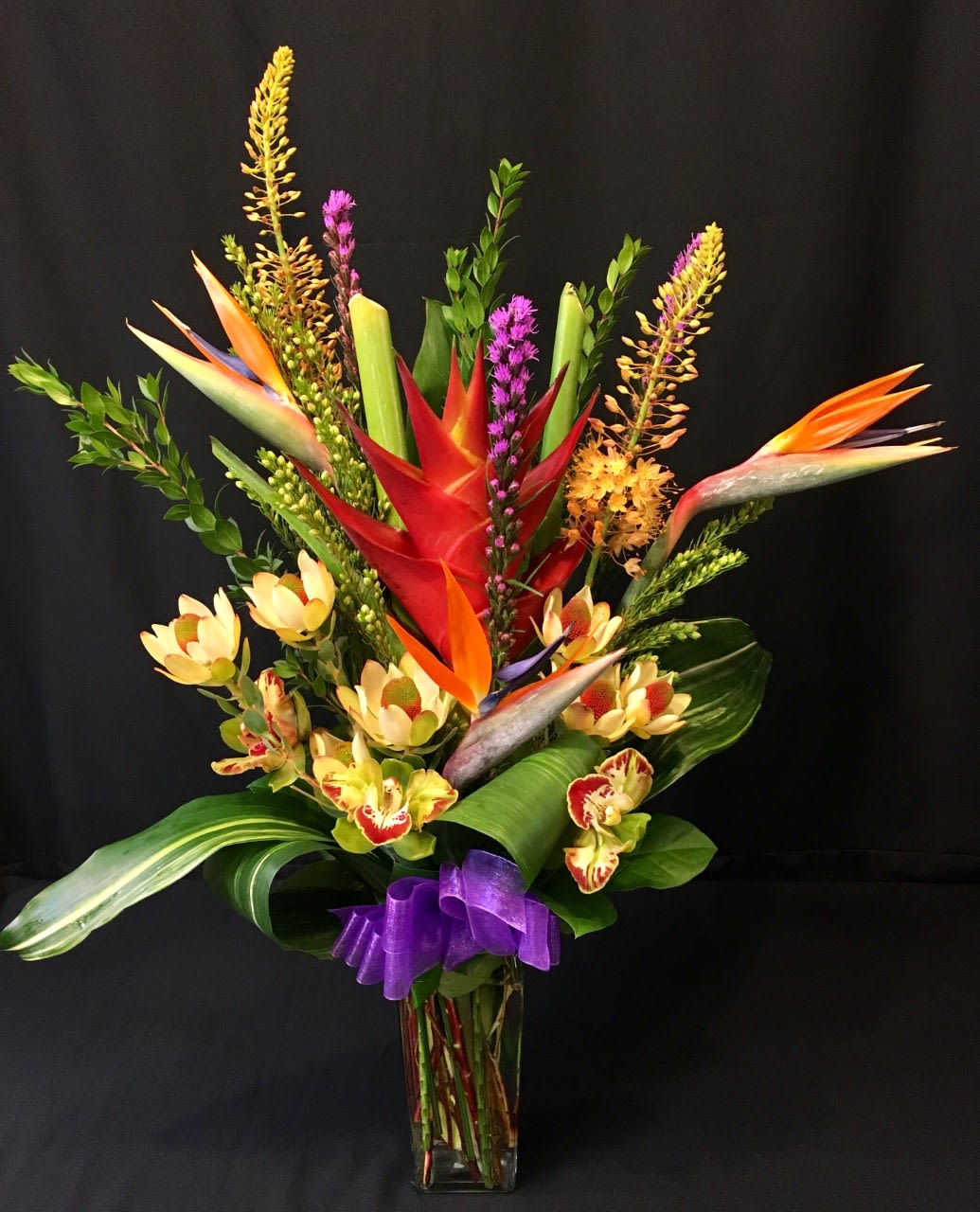 Heliconia Protea Eremurus Large Mix - Such a Beauty!!! Rare tropical and exotic flowers in a tall vase arrangement. Stunning!  Assortment will vary. Order at least 2 weeks prior to get the closest representation of this bouquet.  Gorgeous color and variety. Long lasting. 