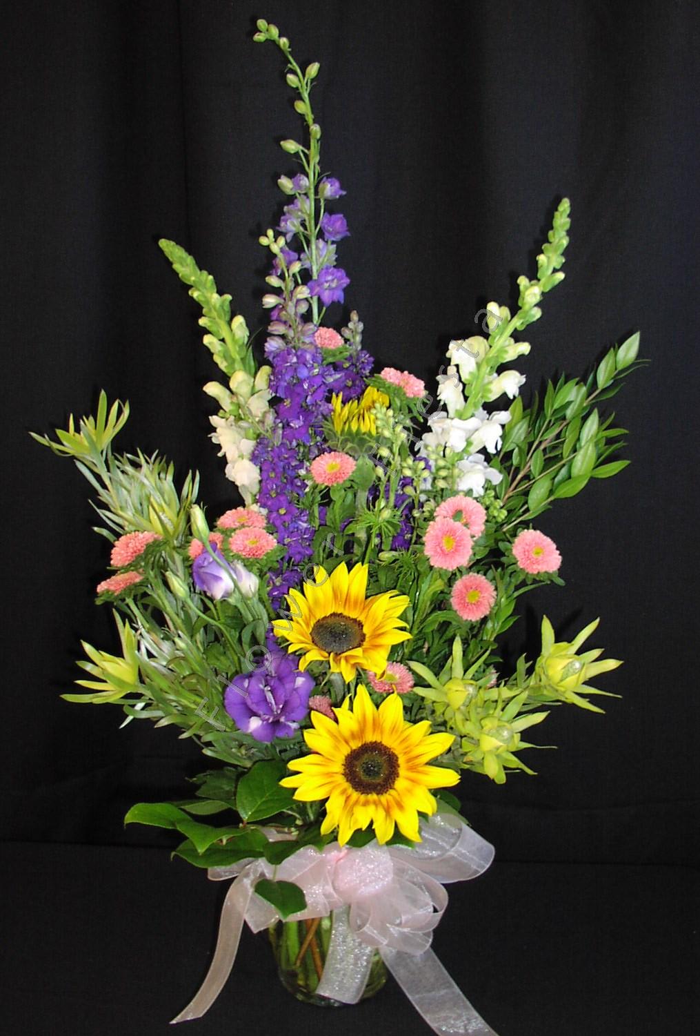 Spring sunflower leucadendron bouquet - Mother's day is the perfect day to express your gratitude for all she does for you all year.  This tall arrangement comes with some exotic flowers and the flowers mom loves most.