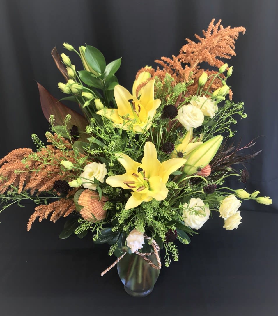 Large Bouquet with Seashells - Ocean bound? Do you celebrate your anniversary gazing at the waves? This tall arrangement has seashells placed throughout. These premium flowers make a great gift for your anniversary or any time of year.*  Flowers  will vary. Order in advance!