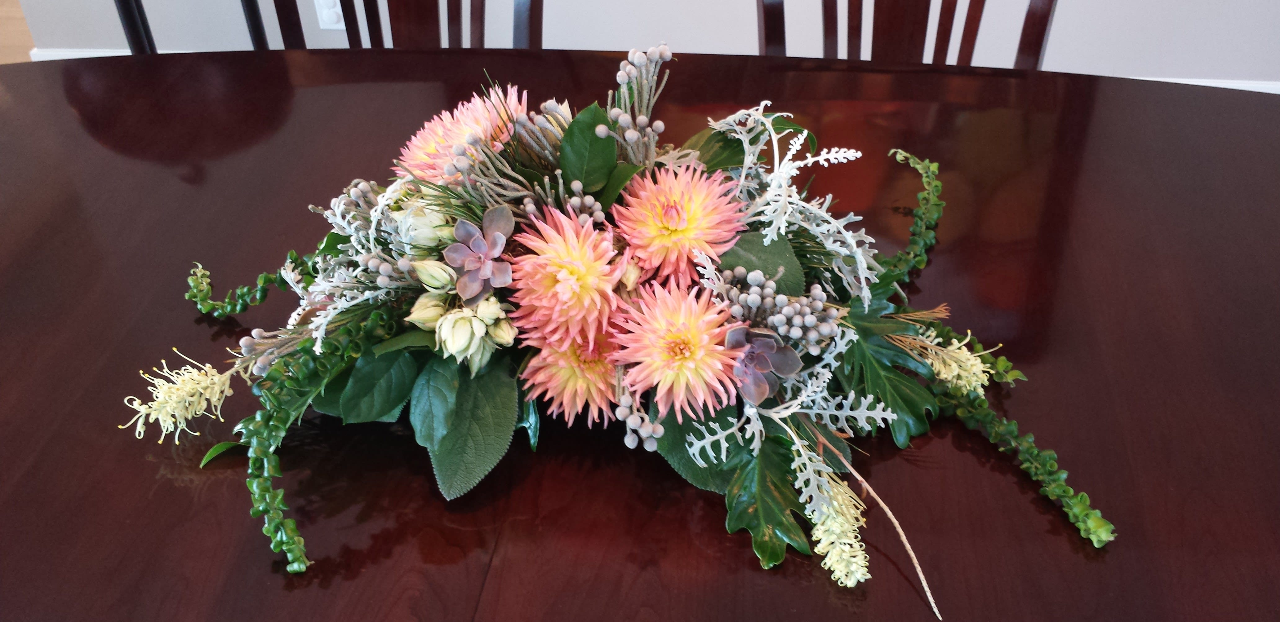 Dahlia Exotic Centerpiece - An eclectic array of fall flowers in a long low design bowl. Colors and items will vary. Designer's choice of accent flowers. Order minimum 10 days in advance to request specific dahlia colors.