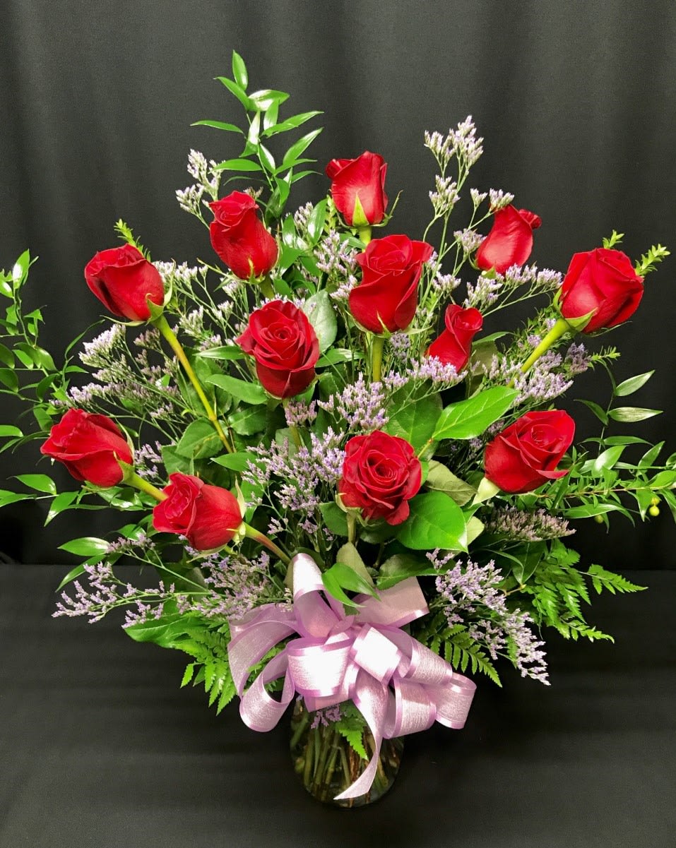 Dozen Premium Long Stem Classic Roses - Red or Colored  - Another version of our Long Stem Red Dozen Roses. Styles may vary.  Red Dozen unless: 1) Red is unavailable due to shorter than 48 hour notice on your order &amp; we will notify you if this is the case or 2) You Choose Colored.  We will choose a color. We cannot guarantee a specific color during Valentine's.  Our premium vased dozen includes filler flowers, lush greenery a gorgeous bow and quality vase. We deliver our roses completely arranged so there is no fuss to find scissors. All of this is included; there are no hidden costs for the best, most perfect roses you will find. Vase, filler flowers and greenery may vary.  The roses we carry are Colombian roses and Ecuadorian roses, which are much bigger than red California roses.