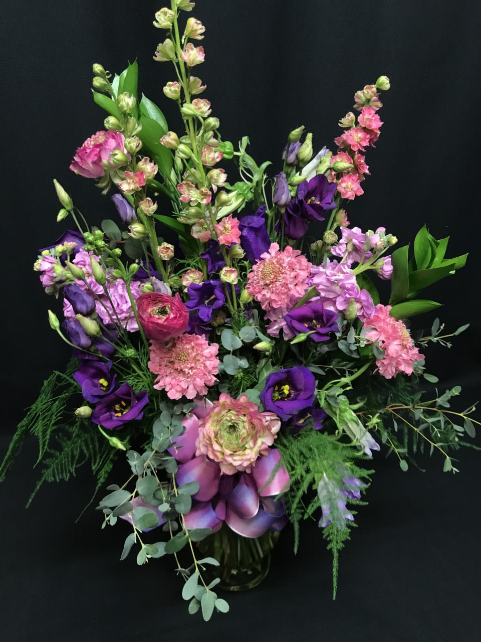 Purple and pink mixed bouquet with eucalyptus in a vase
