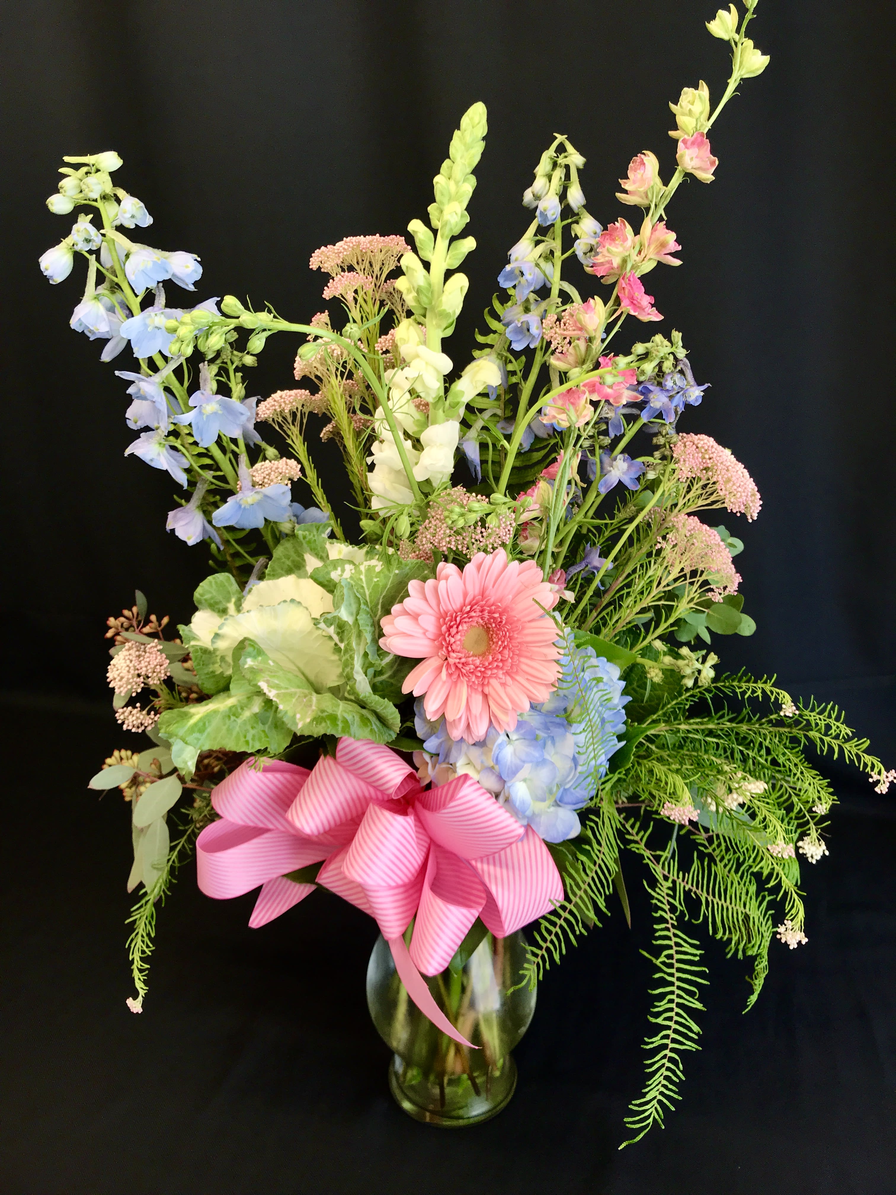 Medium mixed spring flowers with Kale and Pastels - Springtime and perfect for Easter this pastel beauty is tall and festive. Pastel spring flowers will vary. 