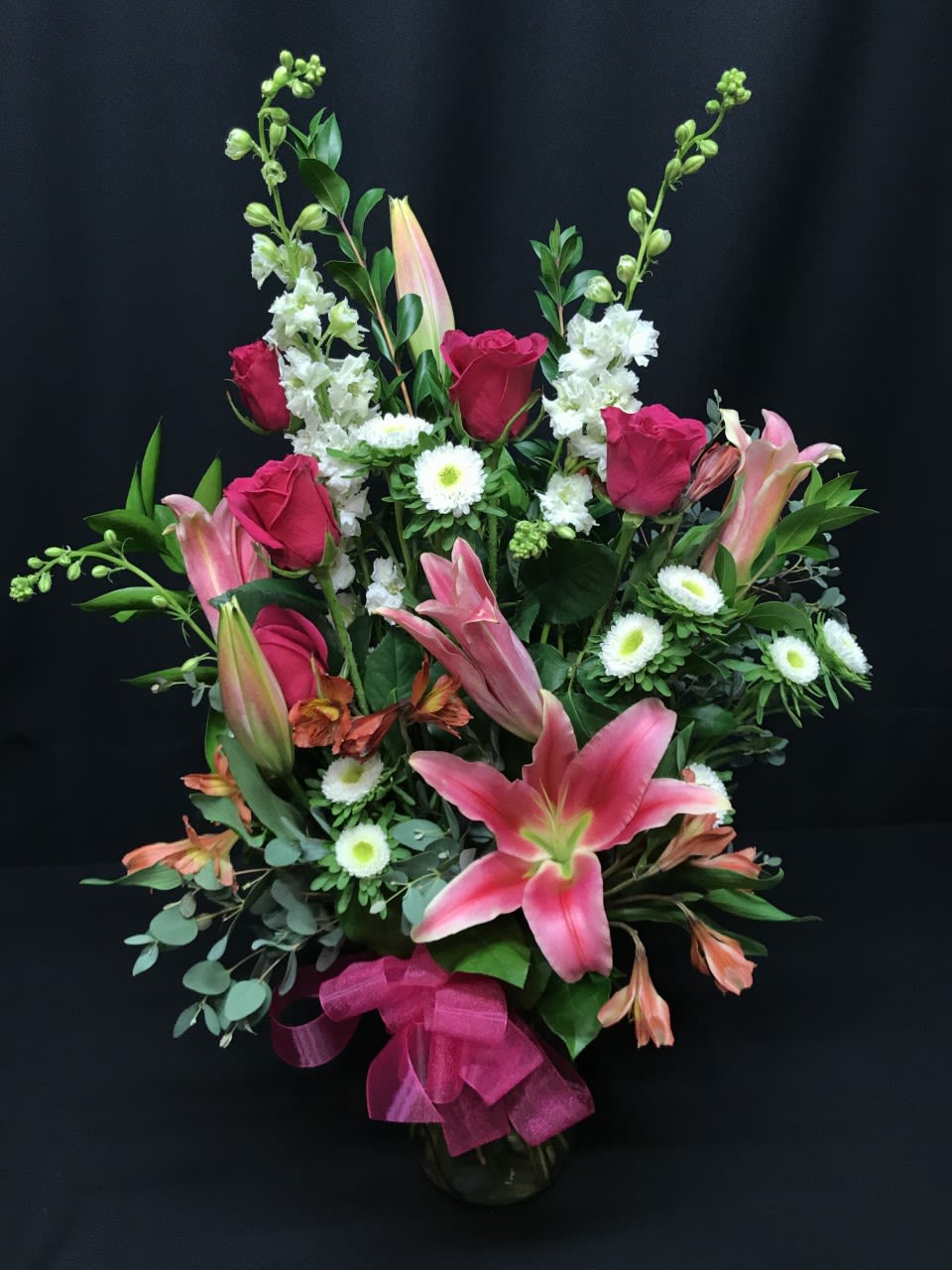 Hot Rose bouquet with Oriental lily - Hot colored roses and big luscious lilies.  Full and all premium assortment. Colors and exact flowers may vary.  Order well in advance.  3 weeks or more in advance for Valentine's day.