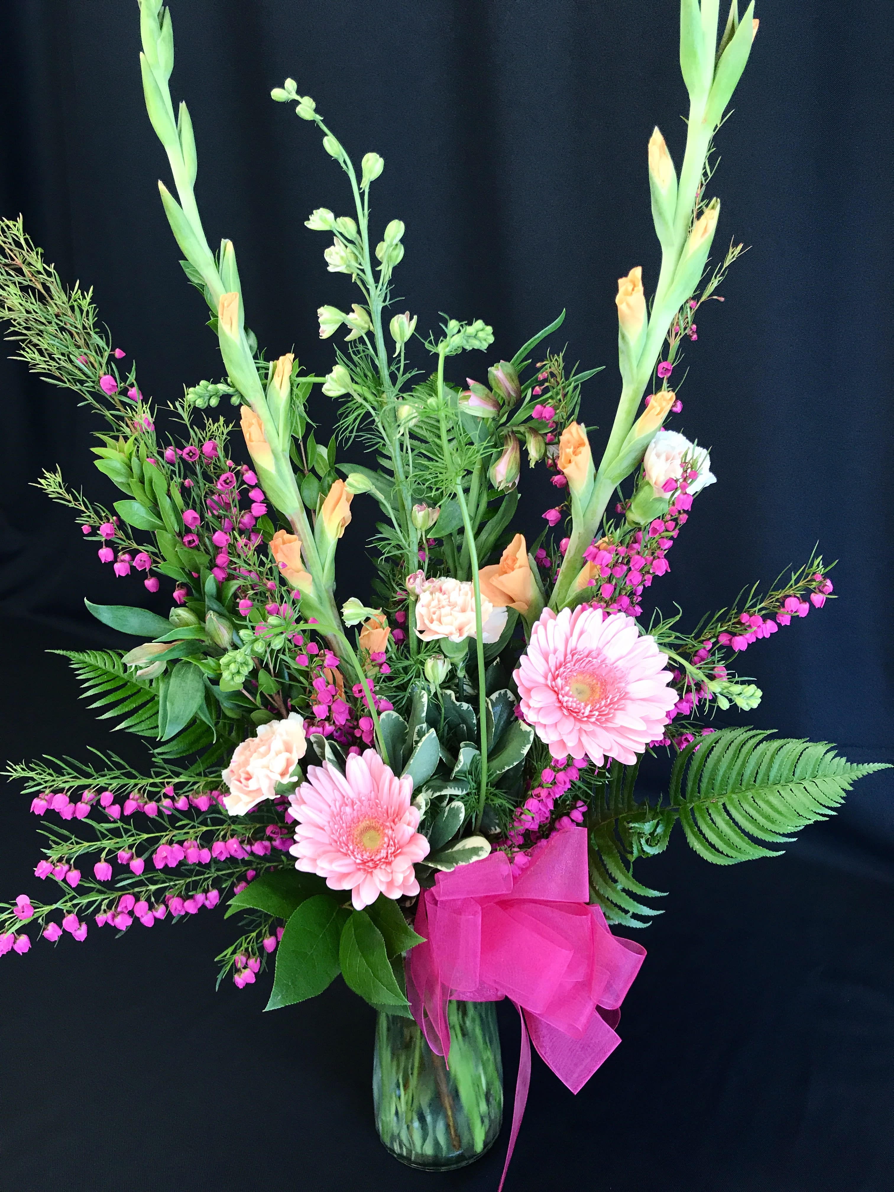 Spring daisies and  boronia - Winter /spring mixed bouquet of seasonal flowers and gerber daisies.  Shown here is a hot pink Boronia flower which is fragrant but only in season for a short duration and may not be available. Colors may vary. Be sure to order in advance. Premium filler flowers and greenery. Nicely arranged in a spray for maximum use of space.