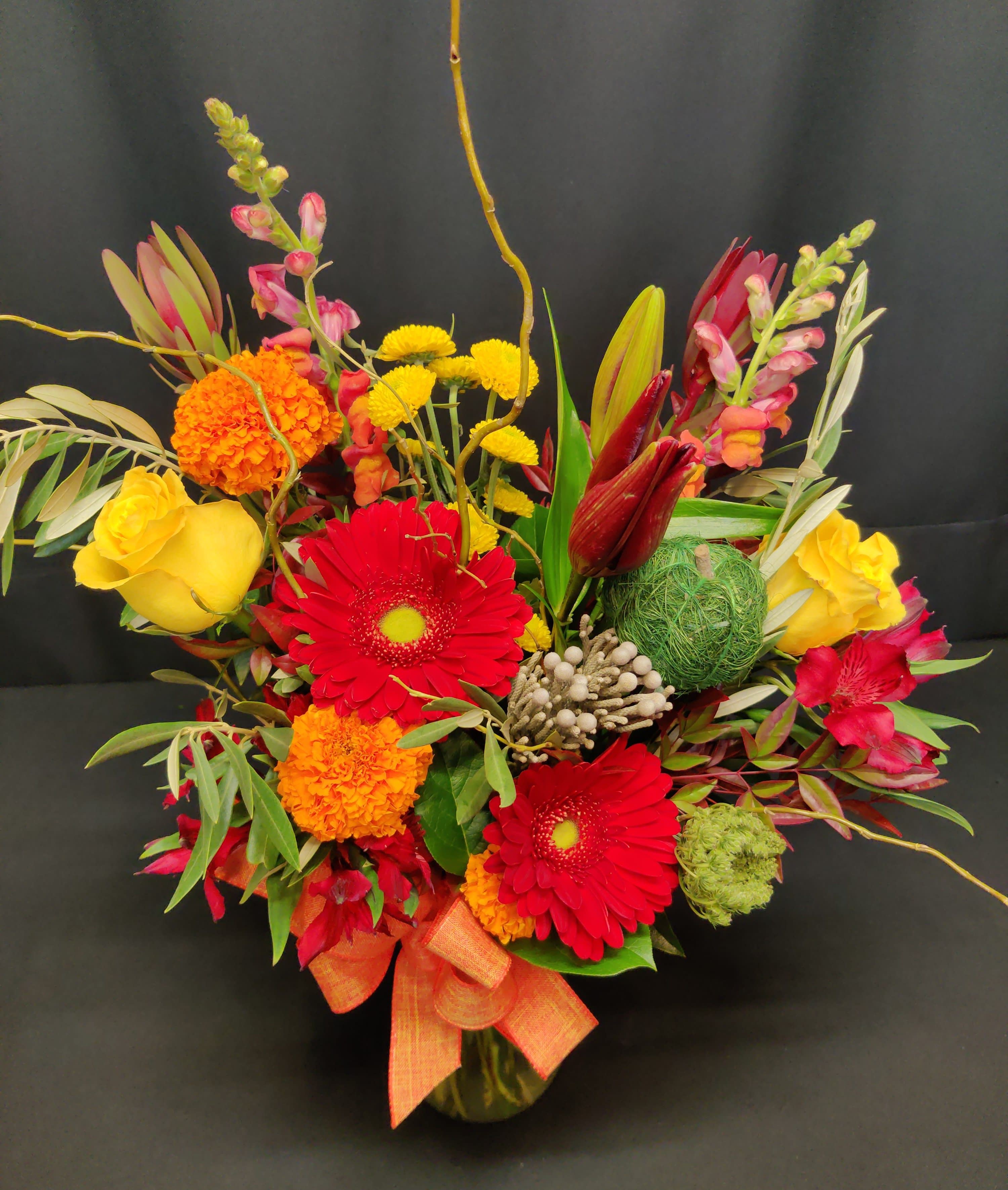 Bold daisy small fall mix - Bright colors will uplift you during the grey fall weather. Powerfully colorful design.  Flowers and accents will vary.  Wonderful get well bouquet or Thank you flowers!