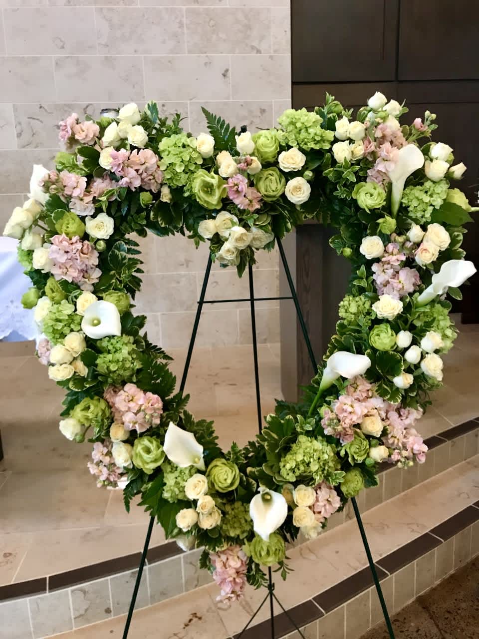 Heart wreath for memorial services, LARGE PREMIUM - Flowers and colors will vary, Be sure to order at least a week ahead to request specific colors or flower varieties. Let us know the personality of your loved one so that we can best design this tribute for them. This is the large 25" size and includes an assortment of premium flowers. We create all sizes and styles at various price points. Be sure to call for help customizing. 