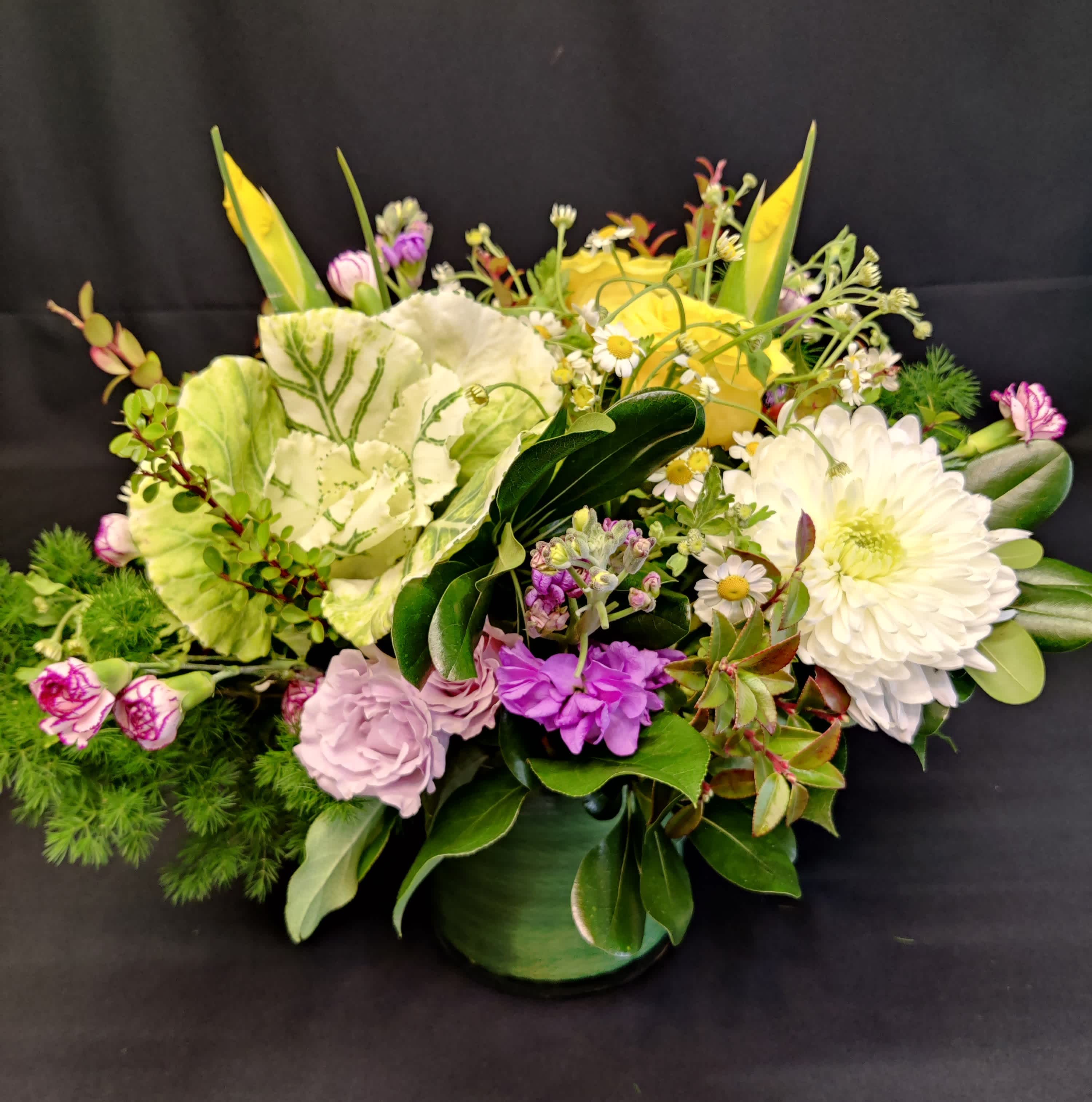Kale long lasting spring centerpiece - Long lasting varieties of flowers and some fresh spring inspiration. Flowers and colors will vary. Centerpiece faces all directions for a dining or coffee table display. 