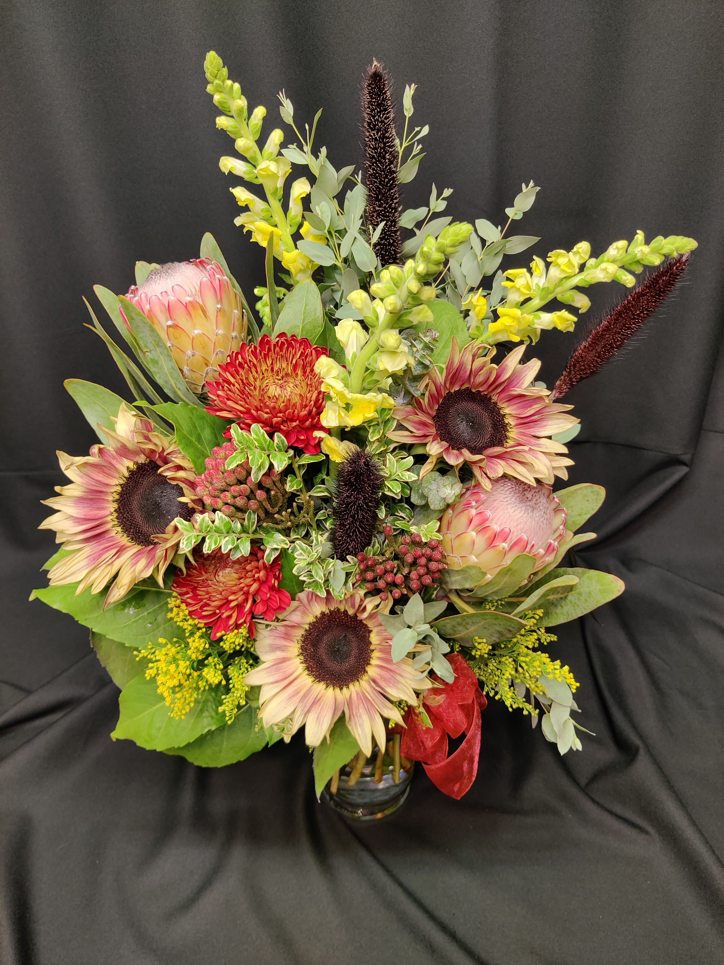 Protea and Eclipse Sunflower - Order WELL Ahead - Rare beauties and must be ordered well ahead of time. We suggest at least a week but feel free to call and confirm availability or we will substitute with closest matches. Gorgeous fall without being overy fall if you know what we mean. Subtle beauties.