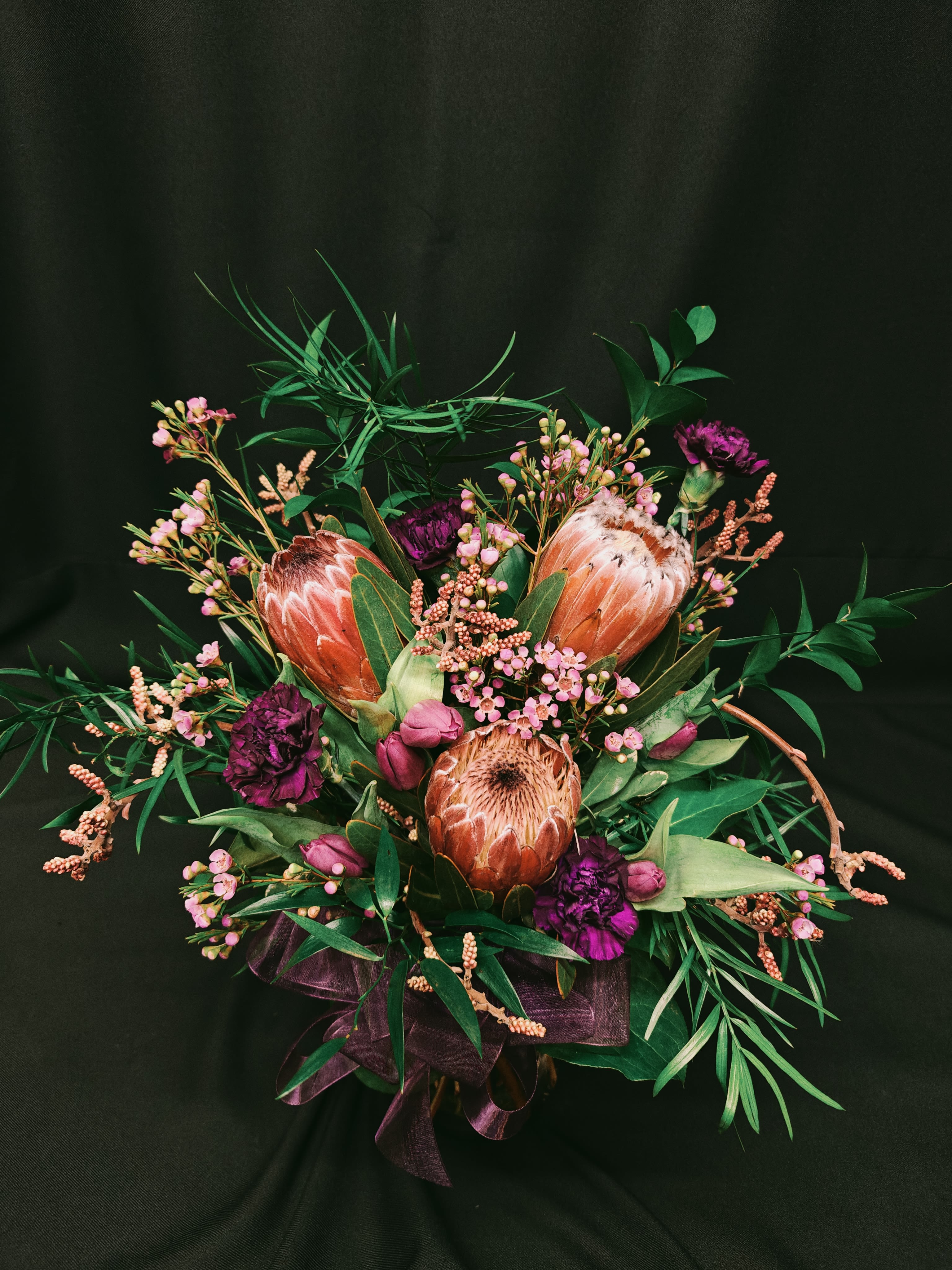 3 Protea Vase - A medium size exotic bouquet.  Big beautiful African protea (exact variety may vary) with an assortment of complimentary flowers. Order ahead as we cannot get exotic protea at the last minute!