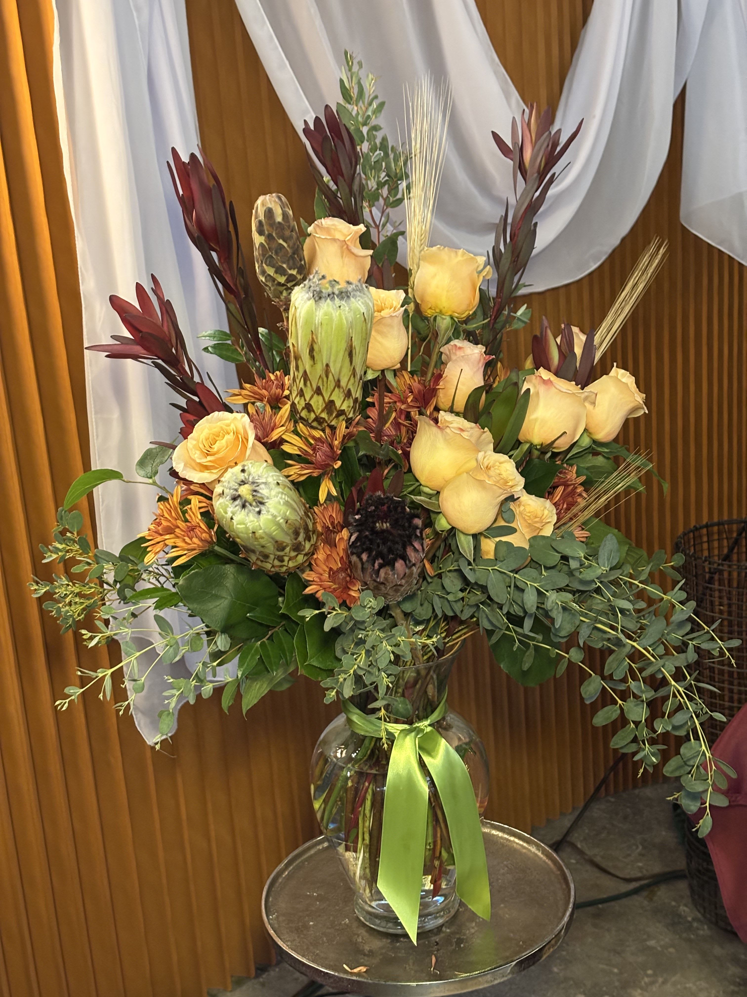 Golden Harvest -   Inspired by the magic of fall, Golden Harvest celebrates the golden tones of the season with a refined blend of warm blooms and natural textures. This arrangement features rich amber, terracotta, and soft gold accents, creating a cozy yet sophisticated look that evokes autumn harvests and glowing sunsets.  Perfect for adding a seasonal touch to any space, Golden Harvest is ideal for homes, events, and special gifts. Designed with the signature artistry of RMC Floral Designs, this piece captures the essence of fall in Seattle, WA, showcasing the craftsmanship of a downtown florist.