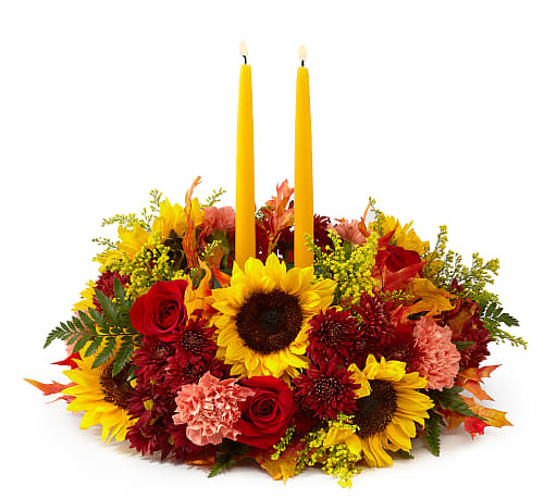 Giving Thanks Candle Centerpiece - Complete your tablescape with a centrepiece that is both fresh and charming. Golden yellow candles surround a mix of sunflowers, roses, and more.