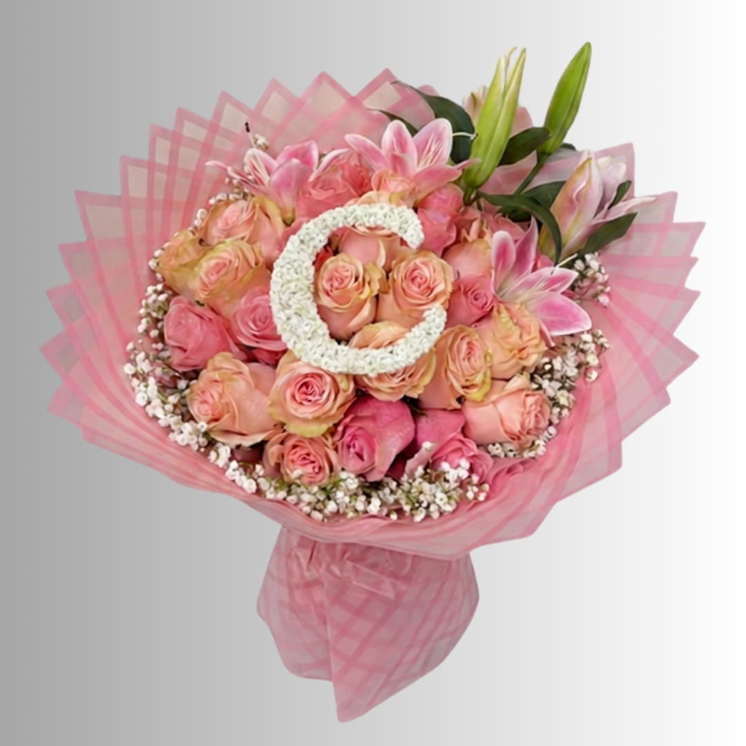 Pink and peach rose bouquet with lilies wrapped in pink mesh