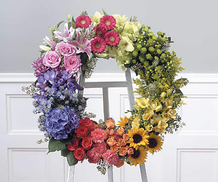 Colorful open wreath of assorted flowers on a standing easel